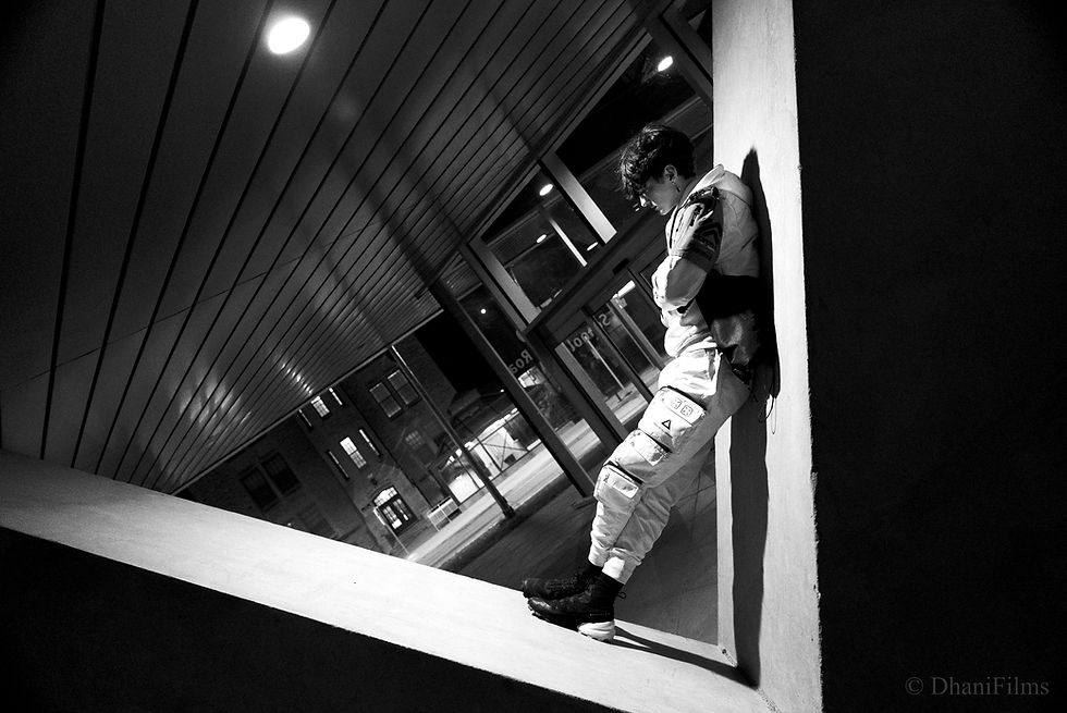 Black and white version of a man standing on a pillar cinematically