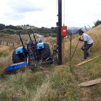 Tractor with post rammer