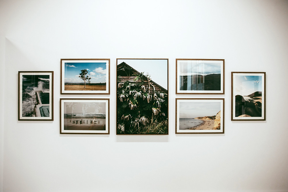 Landscape images hung on the gallery wall.