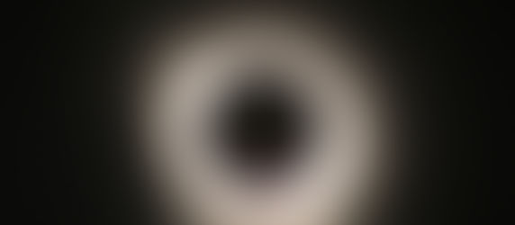 A black circle surrounded by a halo of light.
