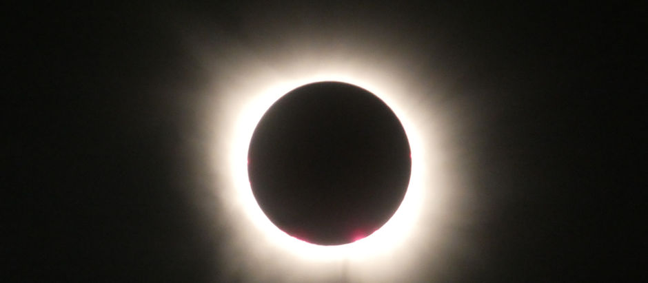 A black circle surrounded by a halo of light.