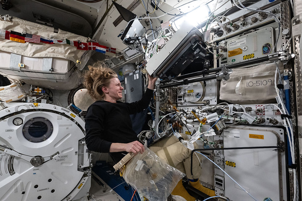An astronaut floats inside the ISS as she performs her maintenance work.