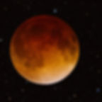 The full moon glows an eerie red during a lunar eclipse.