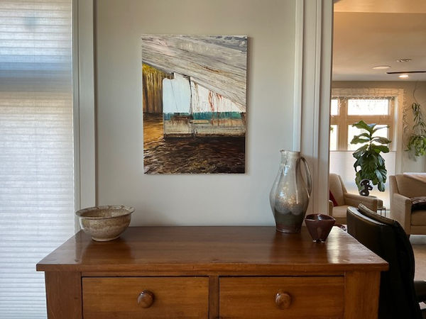Painting of the rudder of the Gazela in afternoon light hung above a credenza