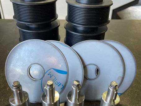 Reverse engineered shafts, serpentine pulleys and splash guard components machined by Pinney Engineering Services.