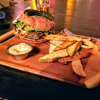 Burger and fries on a serving board