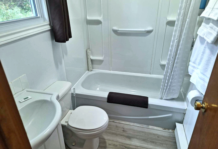 clean bathroom with toilet, sink and bathtub