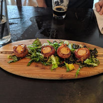 Bacon wrapped scallops on a serving board