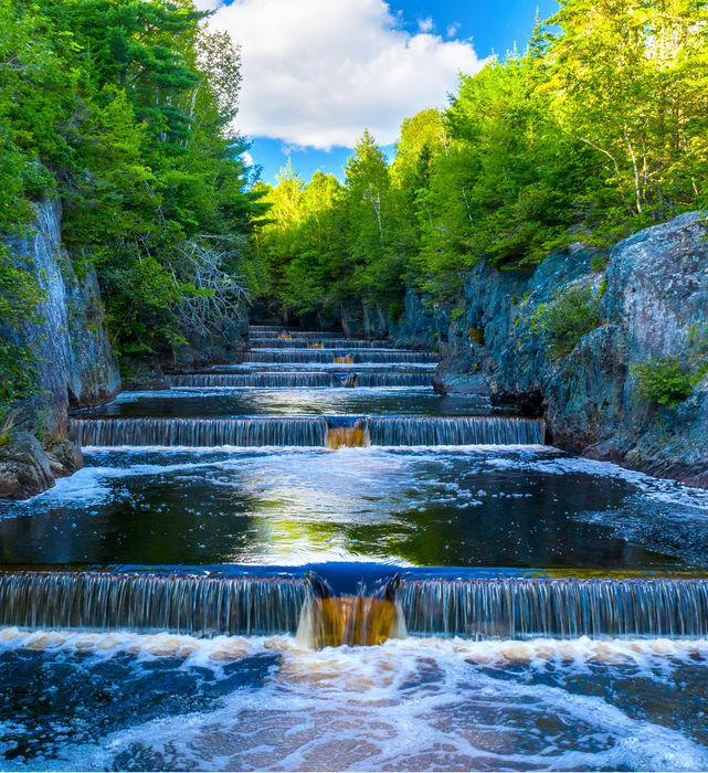a river running with rocking shore on either site