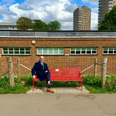 Paul Foster MP sat on a BHF 65 year anniversary bench