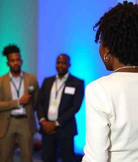 executive, group, business, coaching, programs, stage, African, woman, back view.jpg