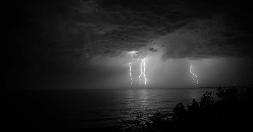 Lightning over water at night