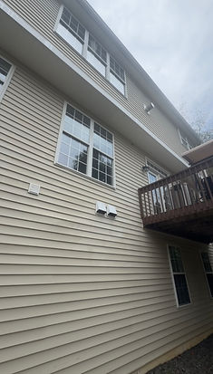 Side view of a two-story home after house washing by Green Eagle Pressure Washing LLC in the Edge of Auburn and Auburn area near US-70, showing clean vinyl siding, windows, and exterior trim following professional soft wash cleaning.