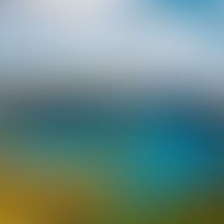 Lush green mountains surround a vibrant blue lake under a partly cloudy sky at Sete Cidades in São Miguel on the Azores. The serene landscape exudes tranquility and natural beauty.