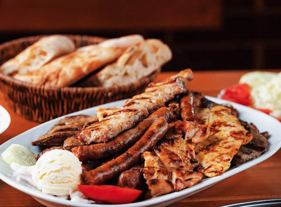 A pile of delicious meat and a basket of bread.