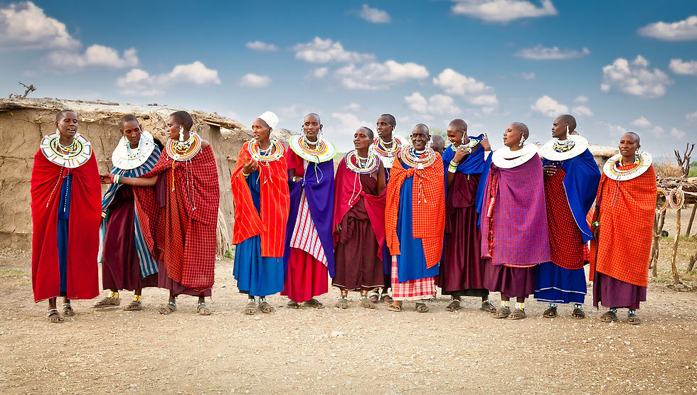 Group of women villagers in Africa dressed in fine, colorful clothing