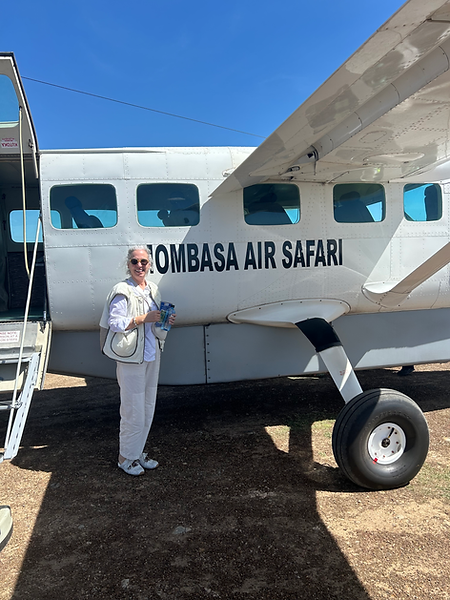 Laurel Louderback in Africa in front of Mombasa Air Safari plane