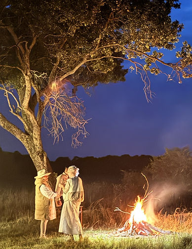 People at night by a campfire on safari in Africa
