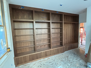 A room featuring wall of large custom cabinetry and millwork, showcasing elegant storage solutions.