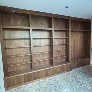 A room featuring wall of large custom cabinetry and millwork, showcasing elegant storage solutions.