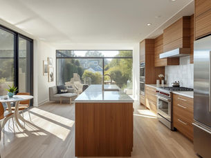 Modern kitchen with wooden floors and a large window, highlighting popular Bay Area remodeling trends.
