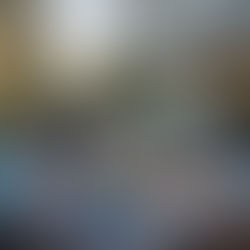 A cozy outdoor living patio featuring wicker furniture and a glass door, designed for comfort and leisure.