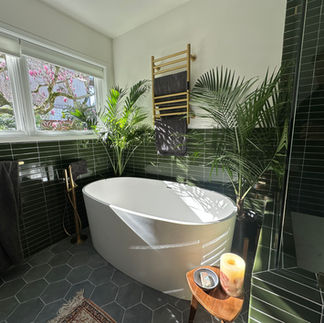 Spa-like bathroom in Bay Area featuring a large tub and elegant green tiles for a relaxing atmosphere.