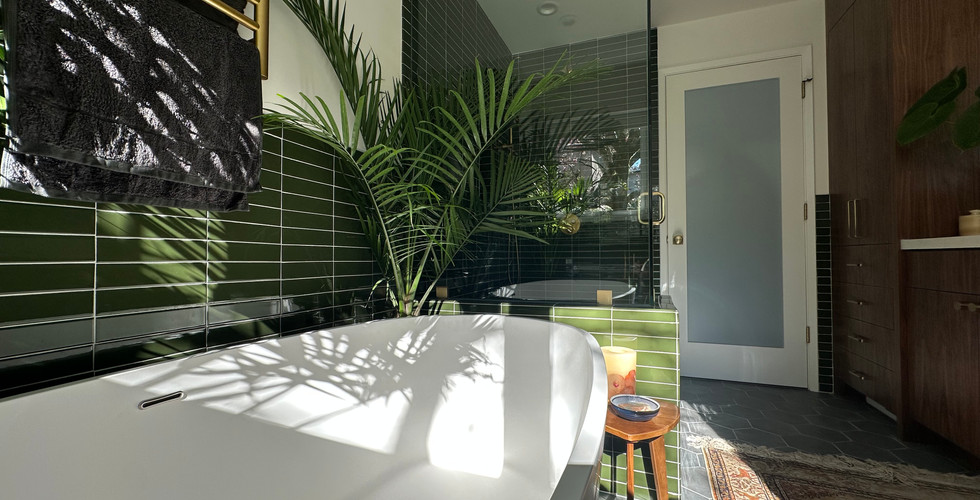 Luxurious bathroom with green tile accents and a large tub, exemplifying spa-like remodeling in the Bay Area.