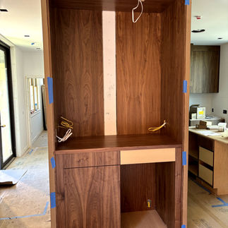 A custom wooden cabinet, providing a functional and stylish workspace solution.