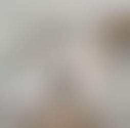 A high-end remodeled kitchen featuring sleek white marble countertops and modern appliances.