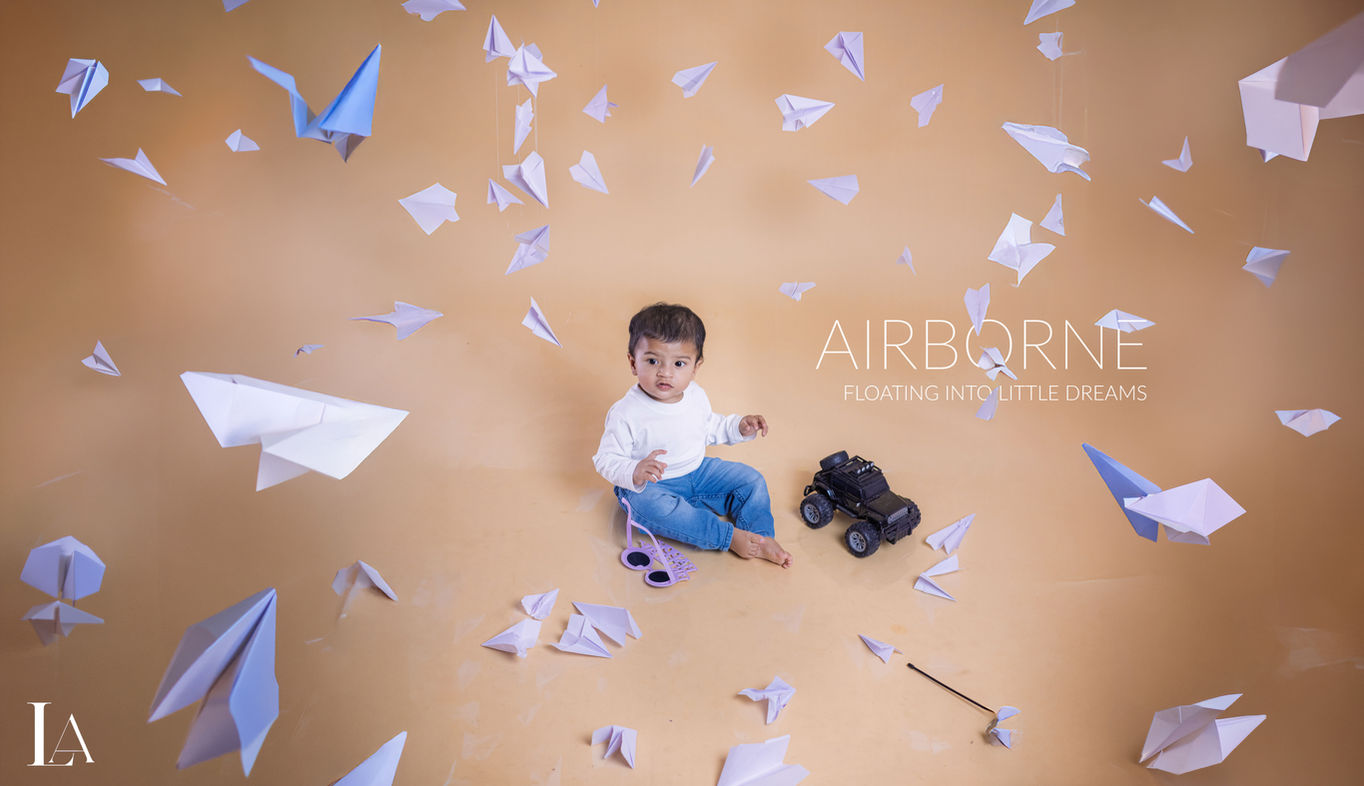 Creative indoor baby photo studio pre-birthday shoot with unique theme setup by LensAction Photography in Vizag