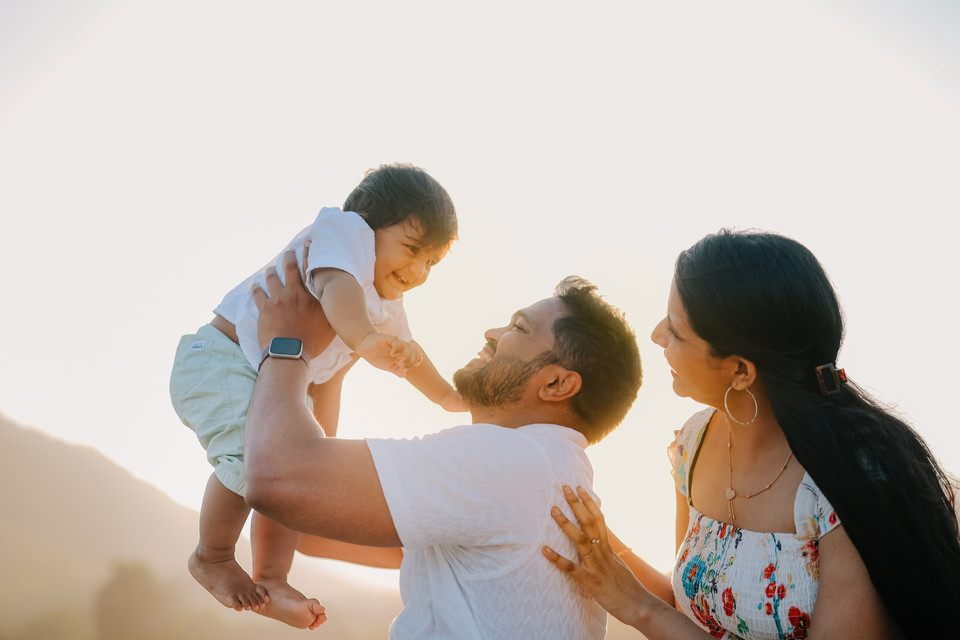 Outdoor pre-birthday family photoshoot of a one-year-old baby during sunset golden hour in Vizag by LensAction Photography
