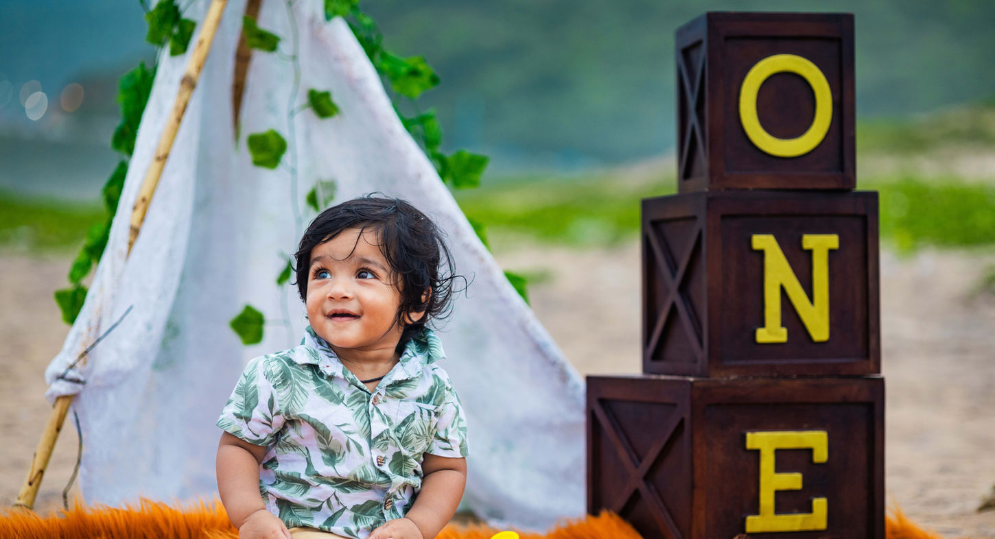Happy toddler smiling face near beach photo by LensAction Photography in Visakhapatnam