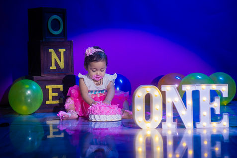 • Happy 1-year-old twins posing together at LensAction Photography studio in Visakhapatnam