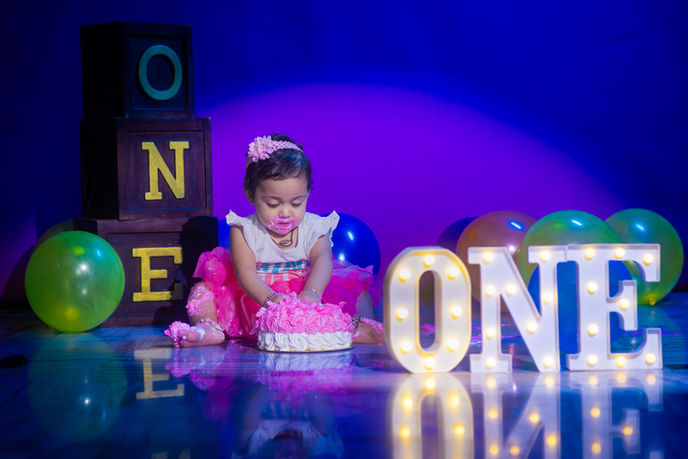 • Happy 1-year-old twins posing together at LensAction Photography studio in Visakhapatnam