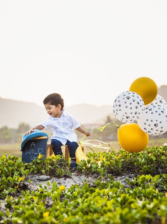Happy toddler smiling face near beach photo by LensAction Photography in Visakhapatnam