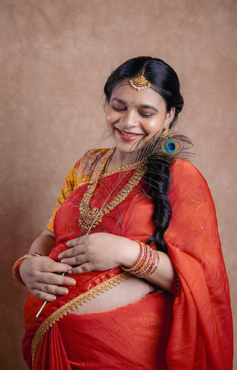 South Indian traditional maternity photoshoot of a pregnant mother in saree, captured by LensAction Photography in Vizag.