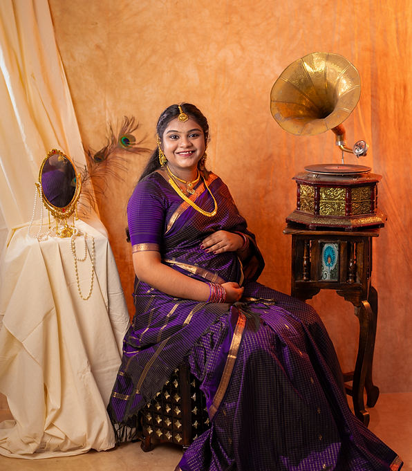 A beautiful traditional maternity portrait captured at LensAction Photography in Visakhapatnam. Featuring an expectant mother dressed in a purple silk saree, this indoor pregnancy photoshoot highlights the joy and anticipation of motherhood. Our maternity photography studio in Murali Nagar, Vizag, offers creative maternity themes, traditional portraits, and professionally captured pregnancy memories.