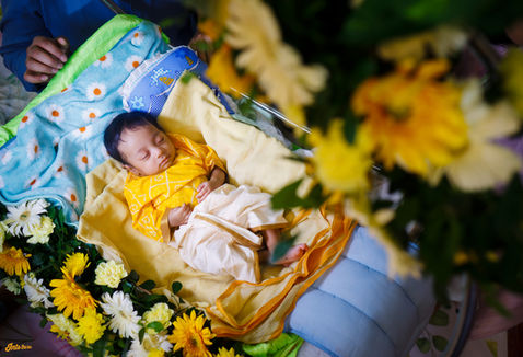 Peacefully sleeping baby in themed decor setup during naming ceremony photoshoot in Vizag