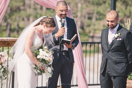 a bride and groom are laughing during their wedding ceremony