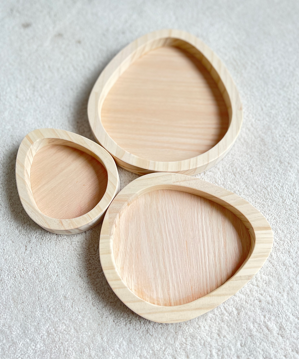 Thumbnail: Three wooden nesting easter egg trays on a white textured surface.