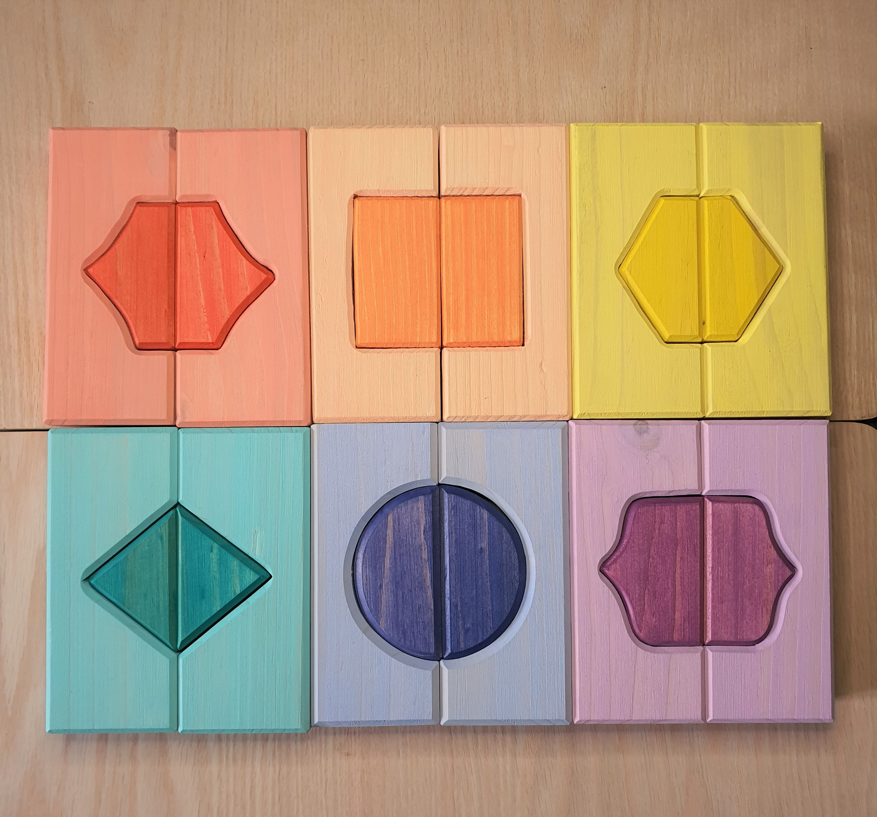 Colorful geometric shapes on wooden tiles, Serenitoys Triangles - Frosted. Education for children.