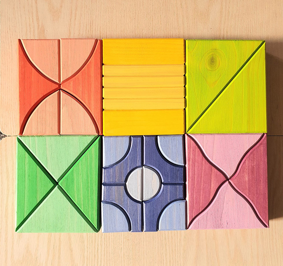 Wooden geometric shapes arranged as a colorful pattern on a light wooden surface.
