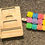 Thumbnail: Wooden tray and colorful blocks with letters and numbers against a rough surface