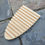 Thumbnail: Wooden soap dish with slatted design on a stone surface.