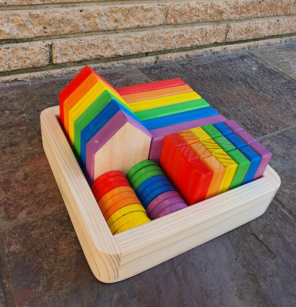 Thumbnail: Rainbow wooden blocks in a wooden tray, Serenitoys Triangles - Frosted, colorful toys for kids.