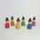 Thumbnail: Colorful wooden figurines wearing hats, standing against a white background.