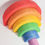 Thumbnail: Wooden rainbow stacker toy in bright colors on a white surface.