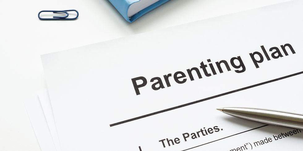 Close-up of a "Parenting plan" document with a pen on white paper. A blue folder and paperclip are visible in the background.