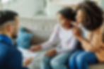 Divorced parents sitting with their child at home, offering support and fostering open communication during back-to-school season